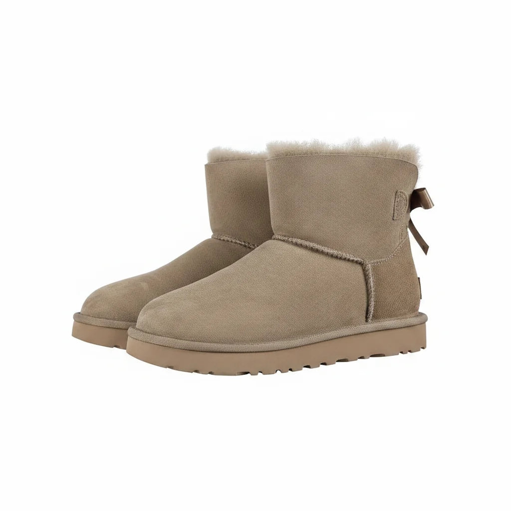 UGG Bailey Bow Mini Ankle Boot – Sand | Shearling-Lined Women's Winter Boot